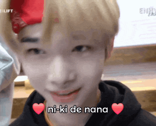 a close up of a person 's face with the words ni-ki de nana written on it .