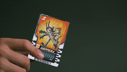 a person is holding a card with a picture of a robot on it