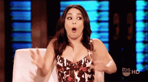 a woman is sitting in a chair with her mouth open and making a funny face .