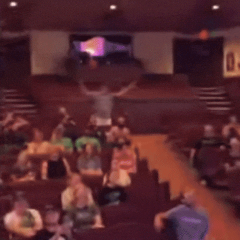 a blurry picture of a group of people in a theater