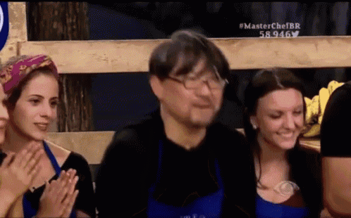 a group of people are clapping in front of a sign that says master chef br
