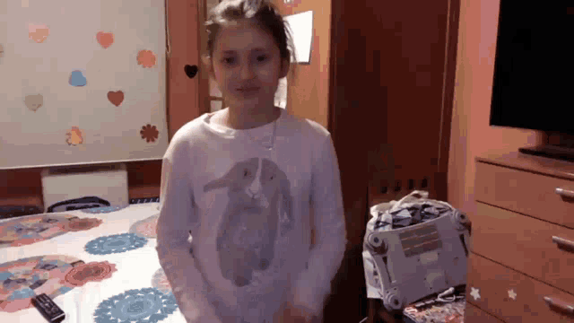 a girl in a white shirt with a bunny on it