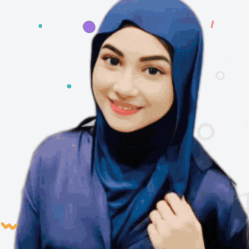 a woman wearing a blue hijab is smiling