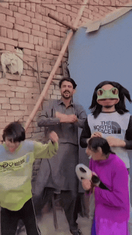 a man in a north face shirt is dancing with a girl