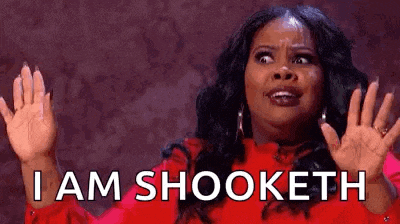 a woman in a red shirt is making a funny face and saying `` i am shooket '' .