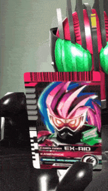 a kamen rider ex-rid card is being held by a hand