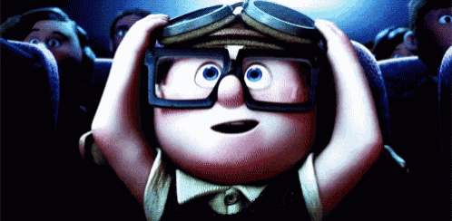 a cartoon character wearing goggles and glasses is sitting in a theater .