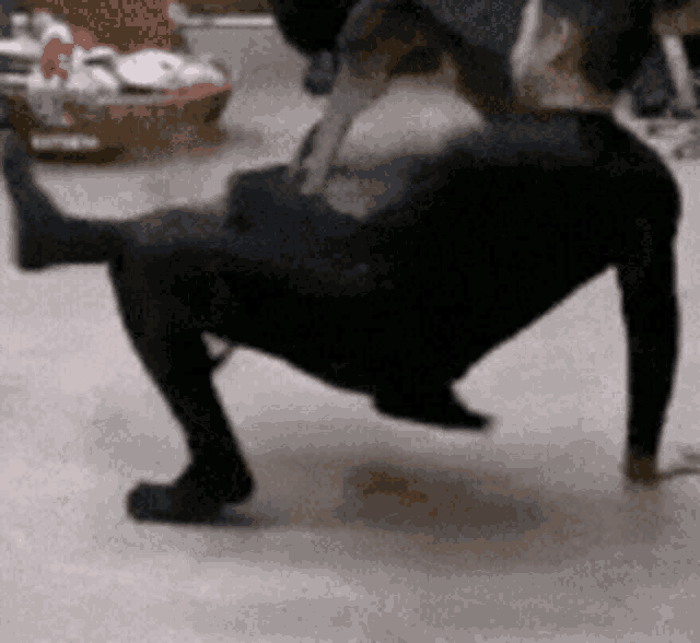 a person is doing push ups on the floor with a basket in the background