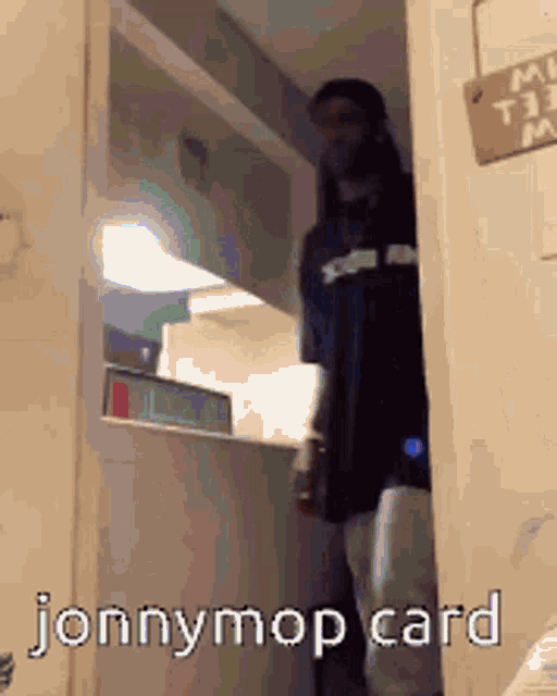 a man standing in a doorway with the words jonnymop card on the bottom