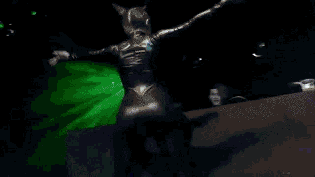 a woman in a catsuit is dancing on a stage .