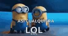 two minions wearing goggles are standing next to each other with the words `` lol '' written on the bottom .