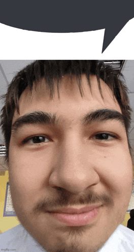 a close up of a man 's face with a white speech bubble behind him