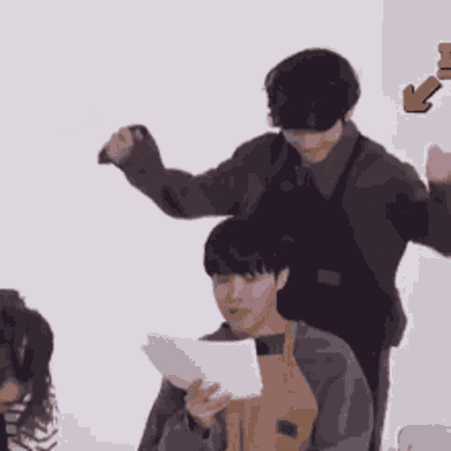 a group of people are standing around a table holding papers .
