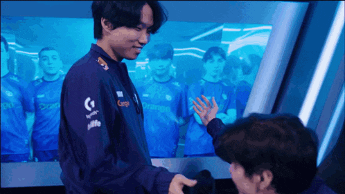 a man in a purple jacket with logitech logos on the sleeves
