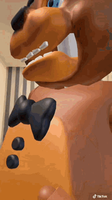 a close up of a teddy bear 's face with a bow tie