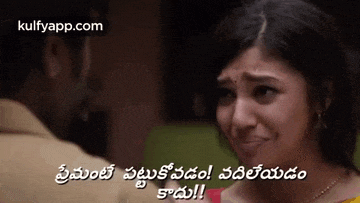a man and a woman are looking at each other and the woman is crying in telugu .