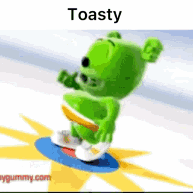 a green gummy bear is riding a skateboard with the words toasty above him