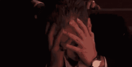 a man in a tuxedo and bow tie is being attacked by a group of men in suits .