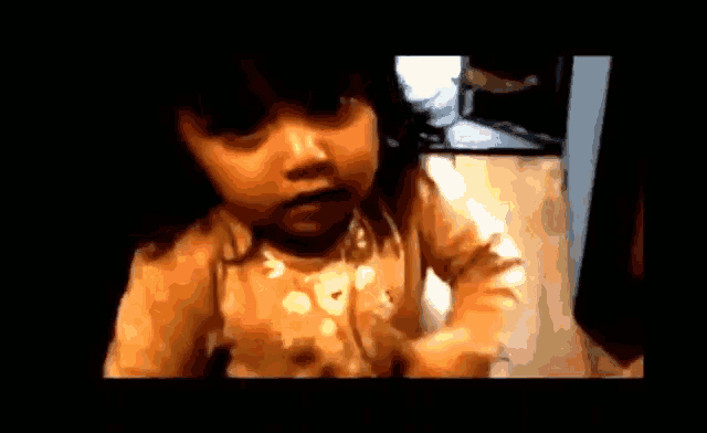 a blurred image of a little girl 's face with a black background
