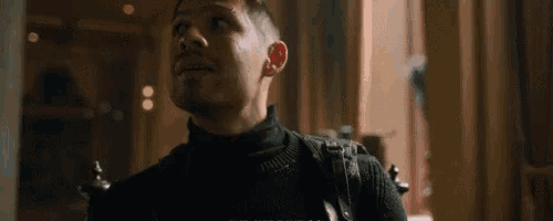 a man wearing a black turtleneck sweater is looking up
