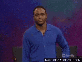 a man in a blue shirt is standing in front of a family channel screen