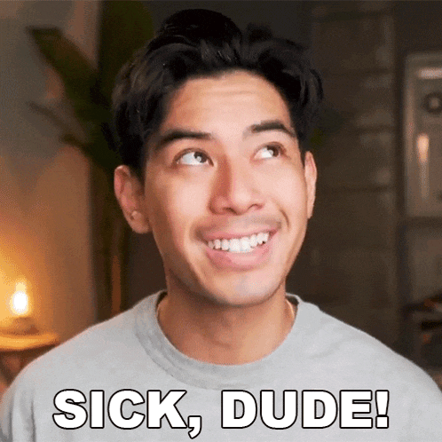 a man in a grey shirt is smiling and saying sick , dude !