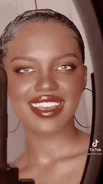 a close up of a woman 's face with a tiktok logo on the bottom right