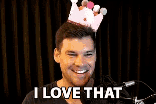 a man with a crown on his head is smiling and says i love that