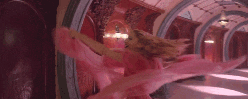 a close up of a person 's ear with a pink smoke coming out of it .