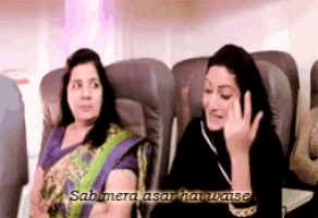 two women sitting on an airplane with the words sab mera afar hai waise written above them