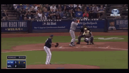 a baseball game is being played in front of a bank beach towel banner