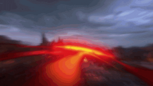 a blurry image of a red and yellow light coming out of the ground