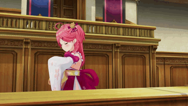 a cartoon character with pink hair is sitting at a table