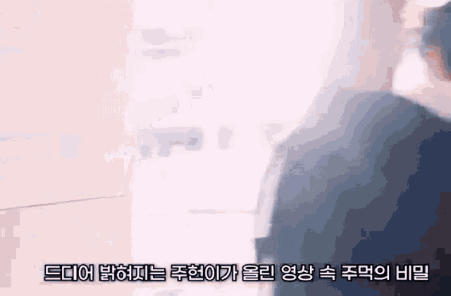 a man in a suit is walking down a hallway with a foreign language caption .