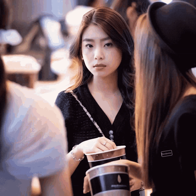a woman wearing a black shirt with a sticker on the sleeve that says ' strawberry ' on it
