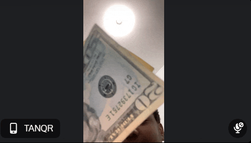 a man is holding a 20 dollar bill in front of his head