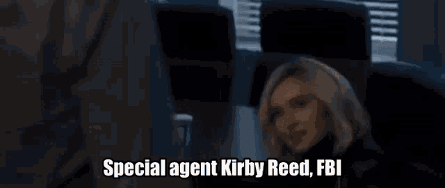 a woman holding a badge that says special agent kirby reed