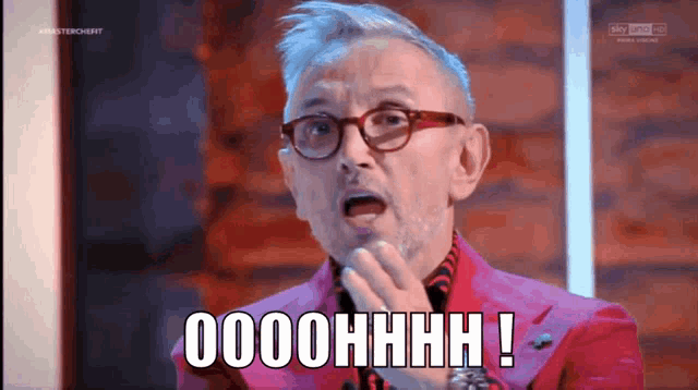 a man wearing glasses and a pink jacket says oooohhhh
