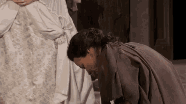 a woman kneeling down with her head down