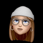 a cartoon girl wearing glasses , a beanie , and a scarf has a surprised look on her face .