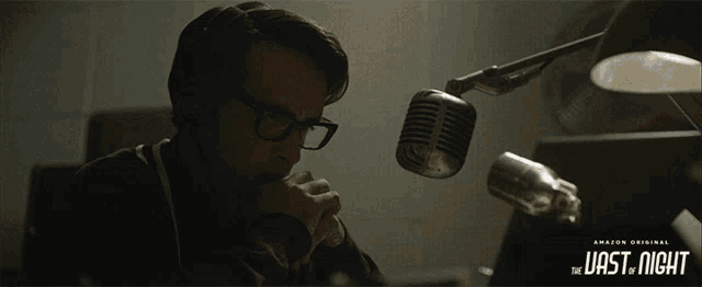 a man sitting in front of a microphone with the last night written on the bottom of the image