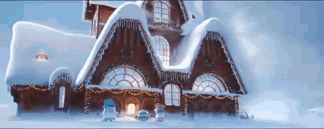 a gingerbread house covered in snow and christmas lights
