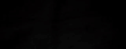 a close up of a black background with a few white lines on it .