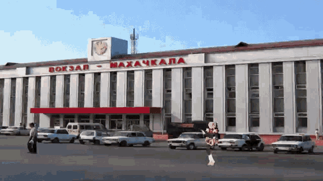 a white building with red letters that says ' вокзал - махачкала '