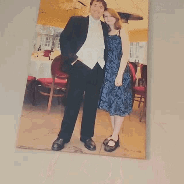 a picture of a man and woman standing next to each other on a wall