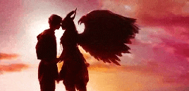 a man and a woman with wings are kissing each other .