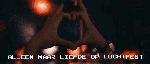 a group of people dancing in a club with the words " alleen maar liefde op luchtfest " on the bottom right