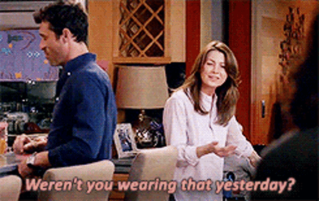 a man and a woman are sitting at a table and the woman is asking if they weren 't wearing that yesterday .