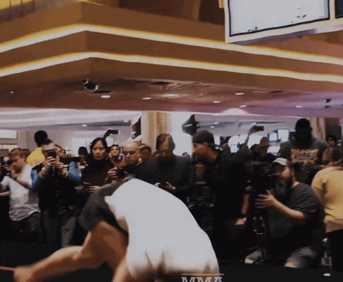 a group of people are gathered around a table that says mma