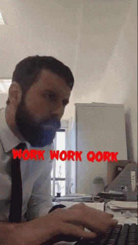 a man with a beard is typing on a keyboard and the words work work qork are visible